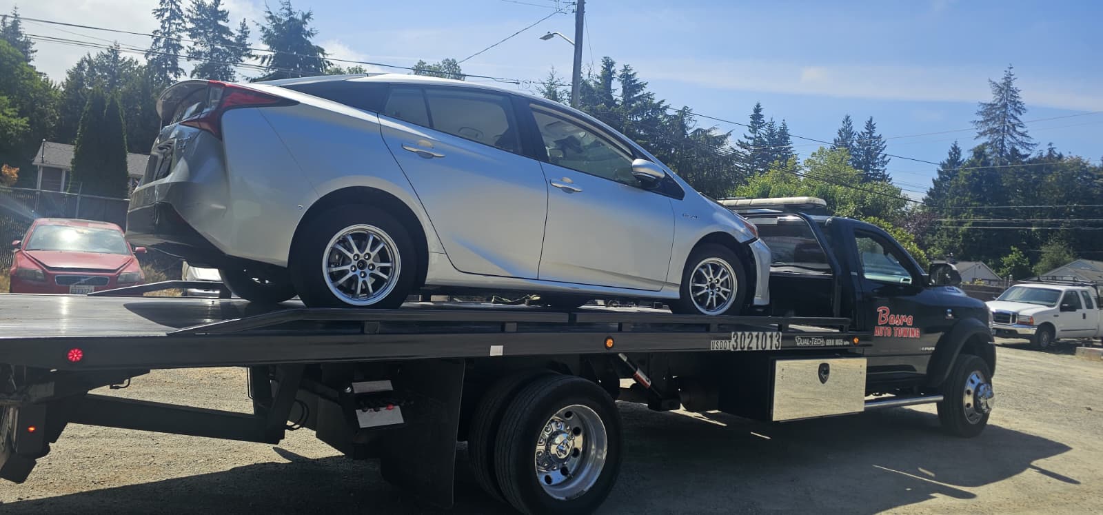 Tow truck transporting a sedan